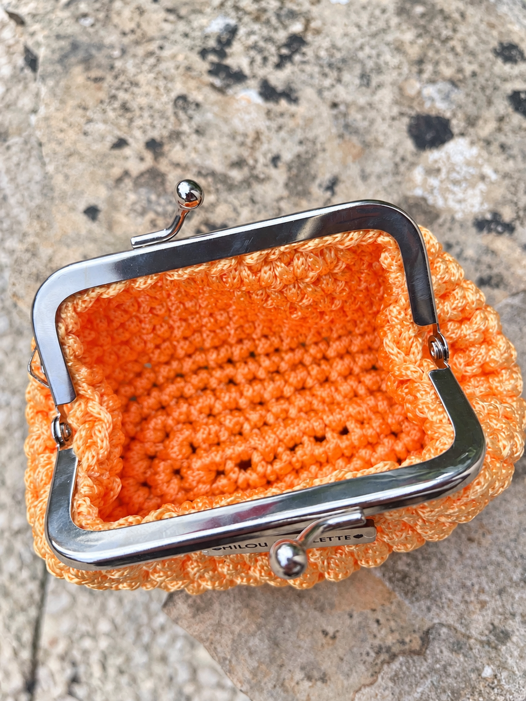 Porte monnaie jaune mandarine posé crocheté à la main en Provence et ouvert